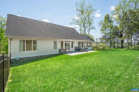 a view of a house with yard and tree s