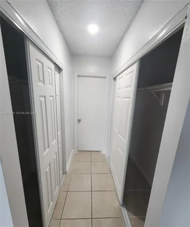 a bathroom with a granite countertop toilet and a sink