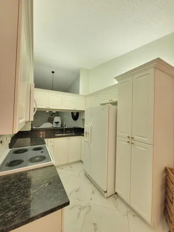 a kitchen with a refrigerator and a stove