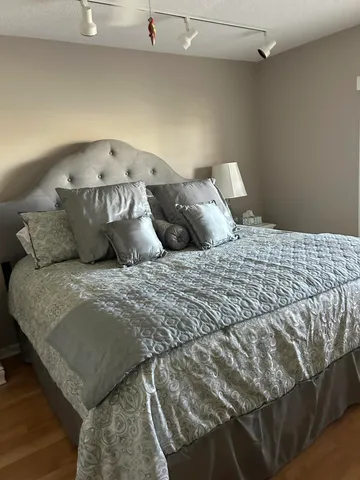 a bed sitting in a bedroom next to a larger window