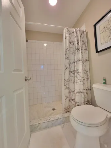 a bathroom with a toilet and shower