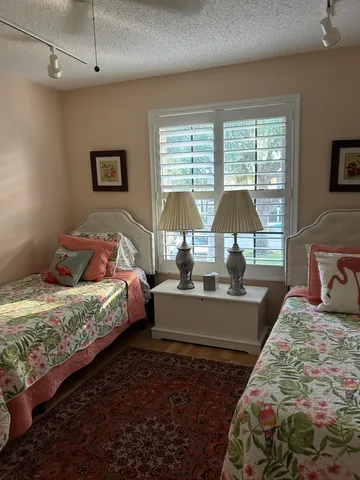 a bed room with a bed window and a table