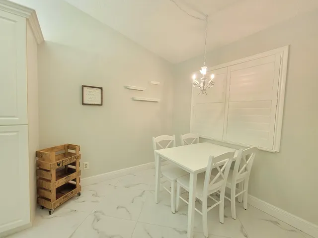 a view of a dining room with furniture and chandelier