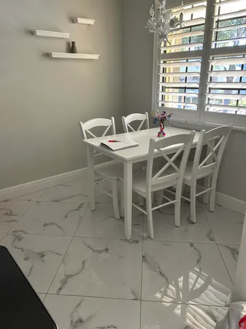 a dining room with furniture and window