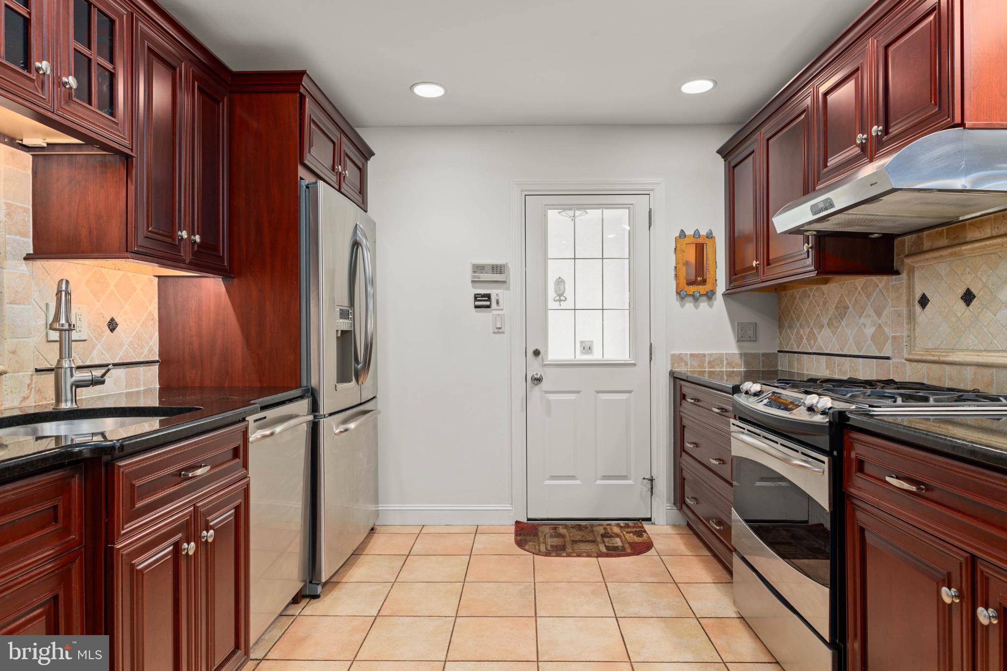 407 Fairview Road Penn Valley, PA 19072 - Photo 14 of 59 Kitchen w/ cherry wood cabinets & SS appliances.