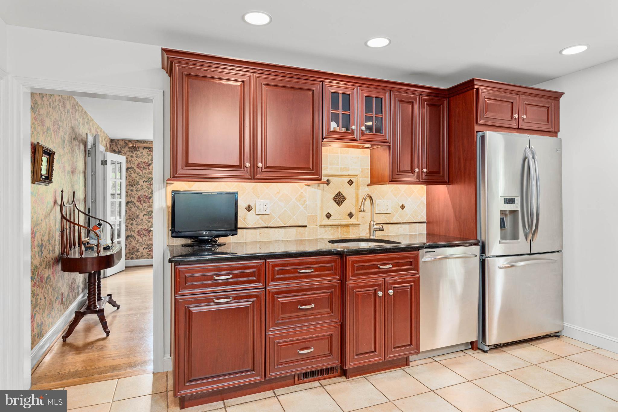 407 Fairview Road Penn Valley, PA 19072 - Photo 15 of 59 Kitchen w/rich wood cabinetry & granite counters.