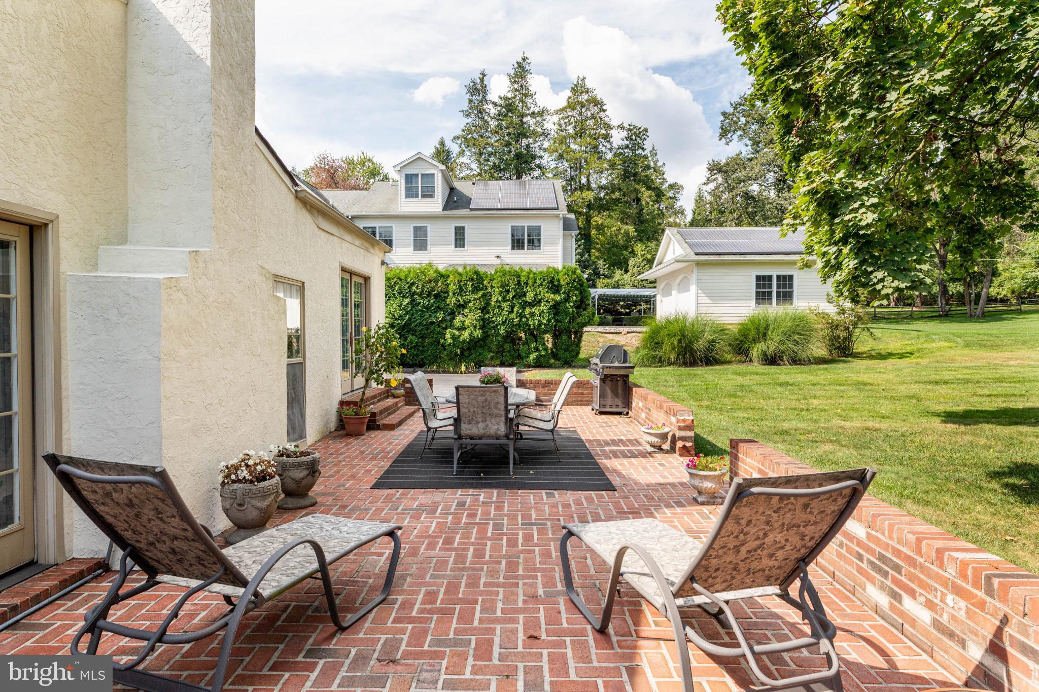 407 Fairview Road Penn Valley, PA 19072 - Photo 49 of 59 Charming patio with lush green surroundings.