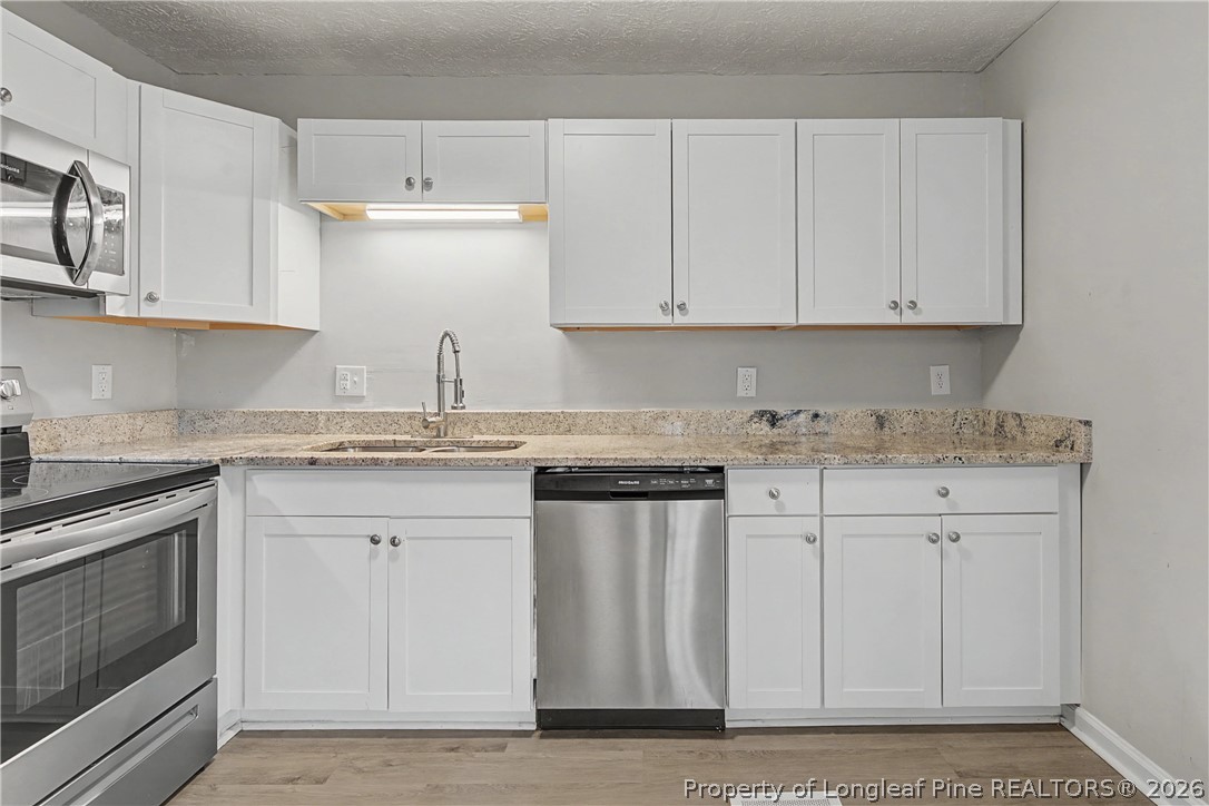 1931 Pumpkin Road Fayetteville, NC 28304 - Photo 19 of 48 a kitchen with granite countertop white cabinets and stainless steel appliances