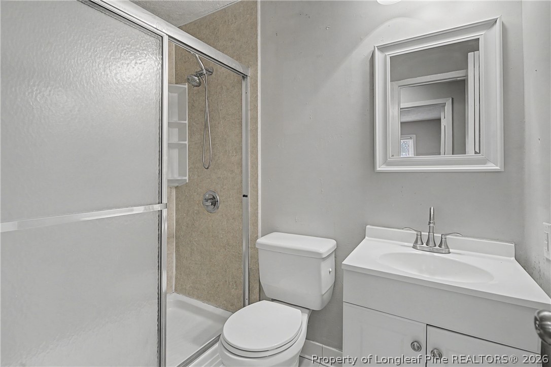 1931 Pumpkin Road Fayetteville, NC 28304 - Photo 35 of 48 a white toilet sitting next to a bathroom sink