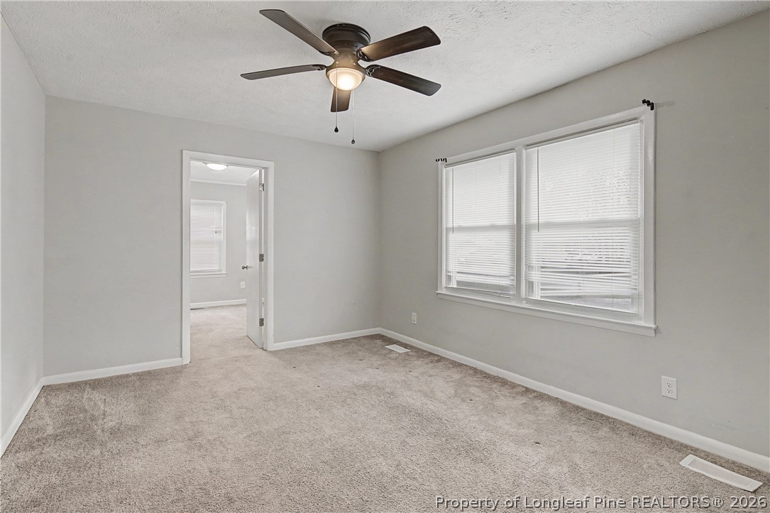 1931 Pumpkin Road Fayetteville, NC 28304 - Photo 7 of 48 an empty room with windows and fan