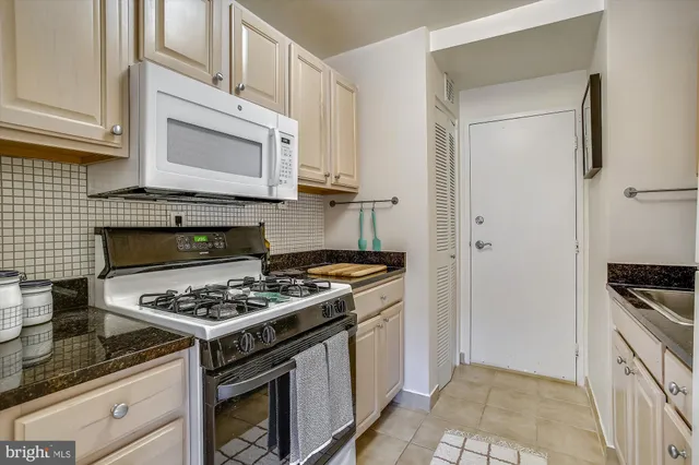 a kitchen with stainless steel appliances granite countertop a stove and a refrigerator