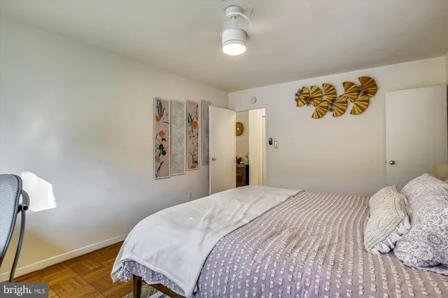 a bedroom with a bed and a painting on the wall