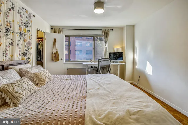 a bedroom with a bed and a painting on the wall