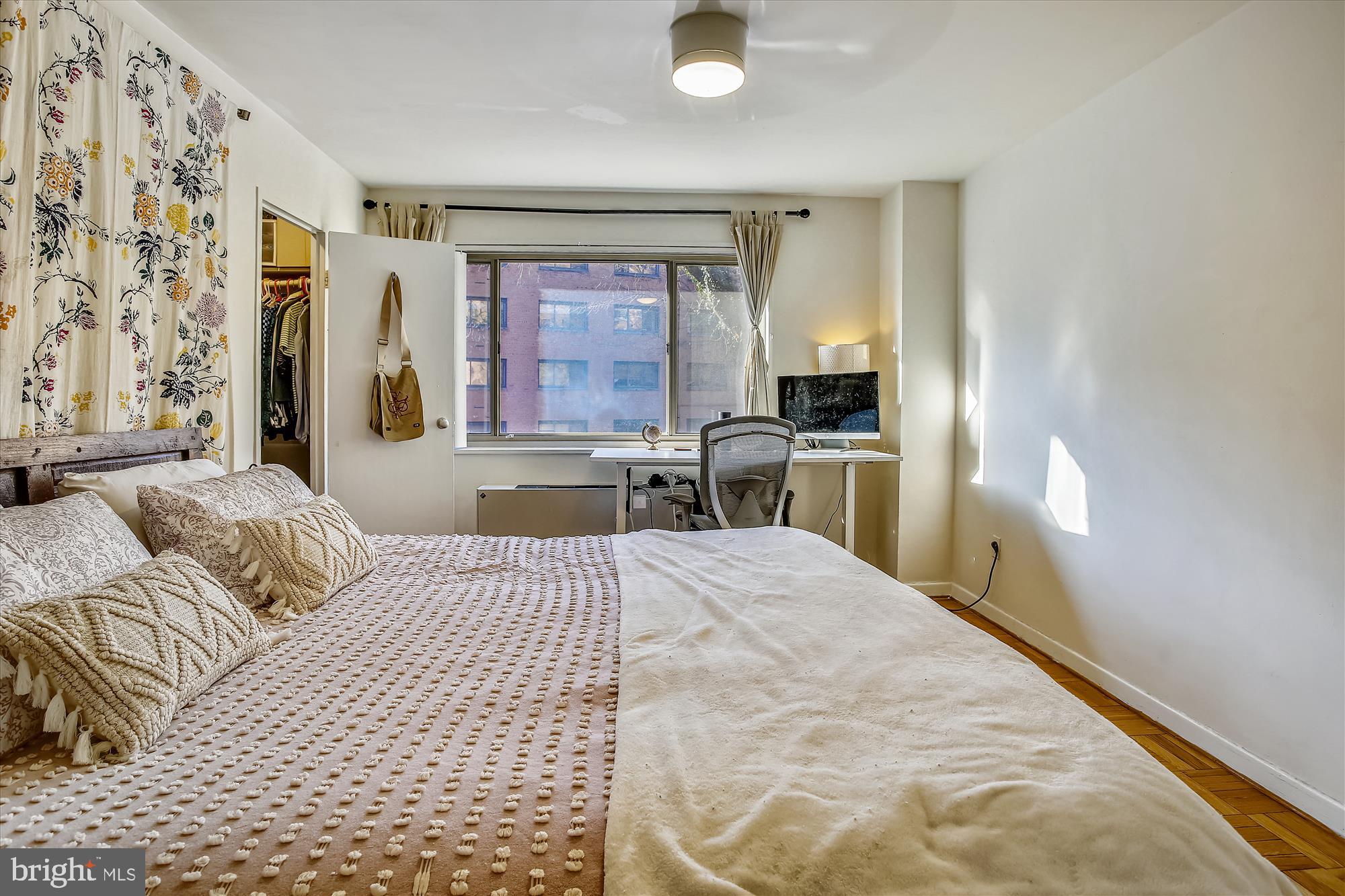 3900 Tunlaw Road Northwest, Unit 118 Washington, DC 20007 - Photo 17 of 58 a bedroom with a bed and a flat screen tv