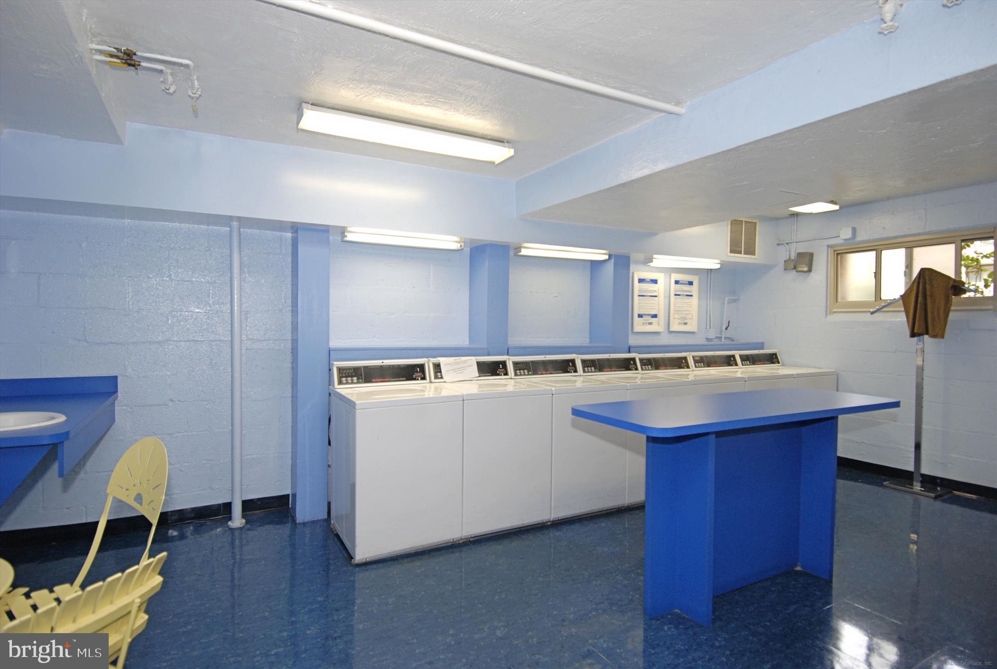 3900 Tunlaw Road Northwest, Unit 118 Washington, DC 20007 - Photo 24 of 58 a large kitchen with a table and chairs