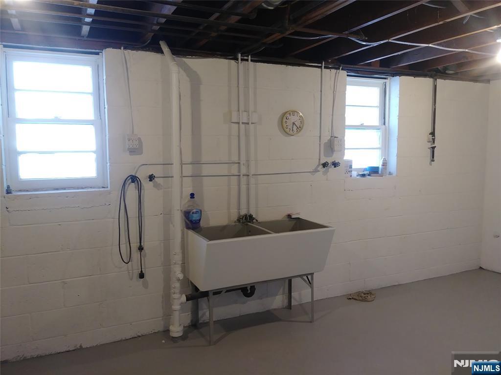 75 Colgate Avenue, Unit 2 Paramus, NJ 07652 - Photo 18 of 24 a bathroom with a sink a toilet and a shower