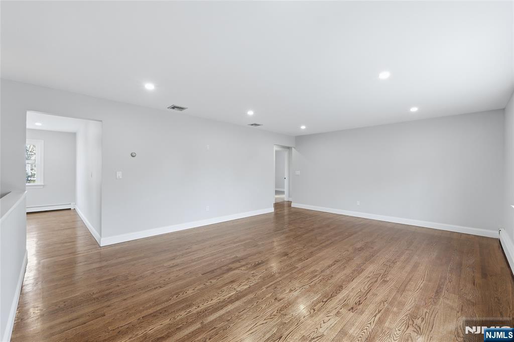 75 Colgate Avenue, Unit 2 Paramus, NJ 07652 - Photo 3 of 24 a view of an empty room with wooden floor