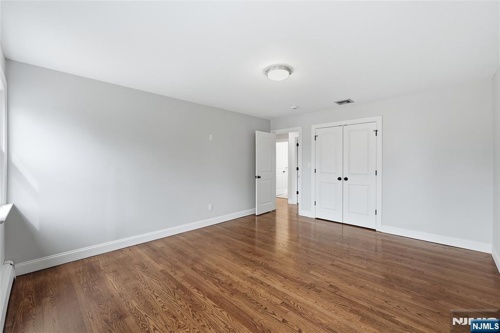 75 Colgate Avenue, Unit 2 Paramus, NJ 07652 - Photo 8 of 24 a view of an empty room with wooden floor