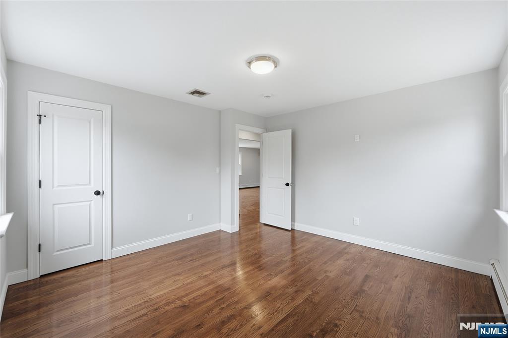 75 Colgate Avenue, Unit 2 Paramus, NJ 07652 - Photo 10 of 24 a view of an empty room with wooden floor