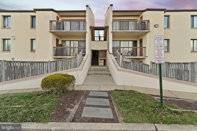 a view of a brick house with many windows
