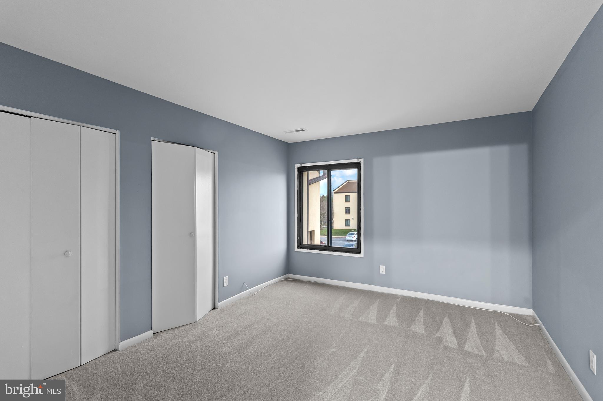 10121 Prince Place, Unit 30110B Upper Marlboro, MD 20774 - Photo 13 of 29 a view of an empty room with a window