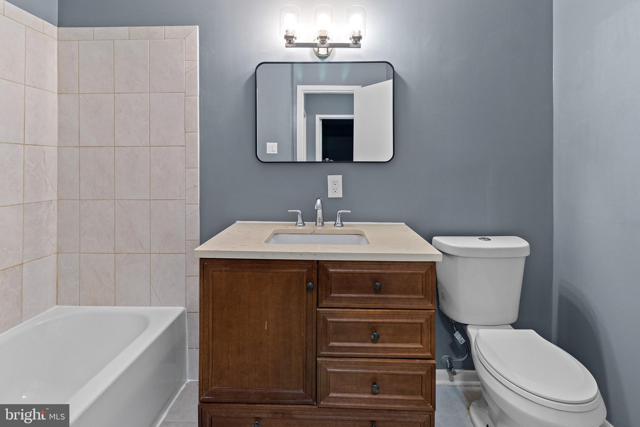 10121 Prince Place, Unit 30110B Upper Marlboro, MD 20774 - Photo 16 of 29 a bathroom with a sink a toilet and bathtub