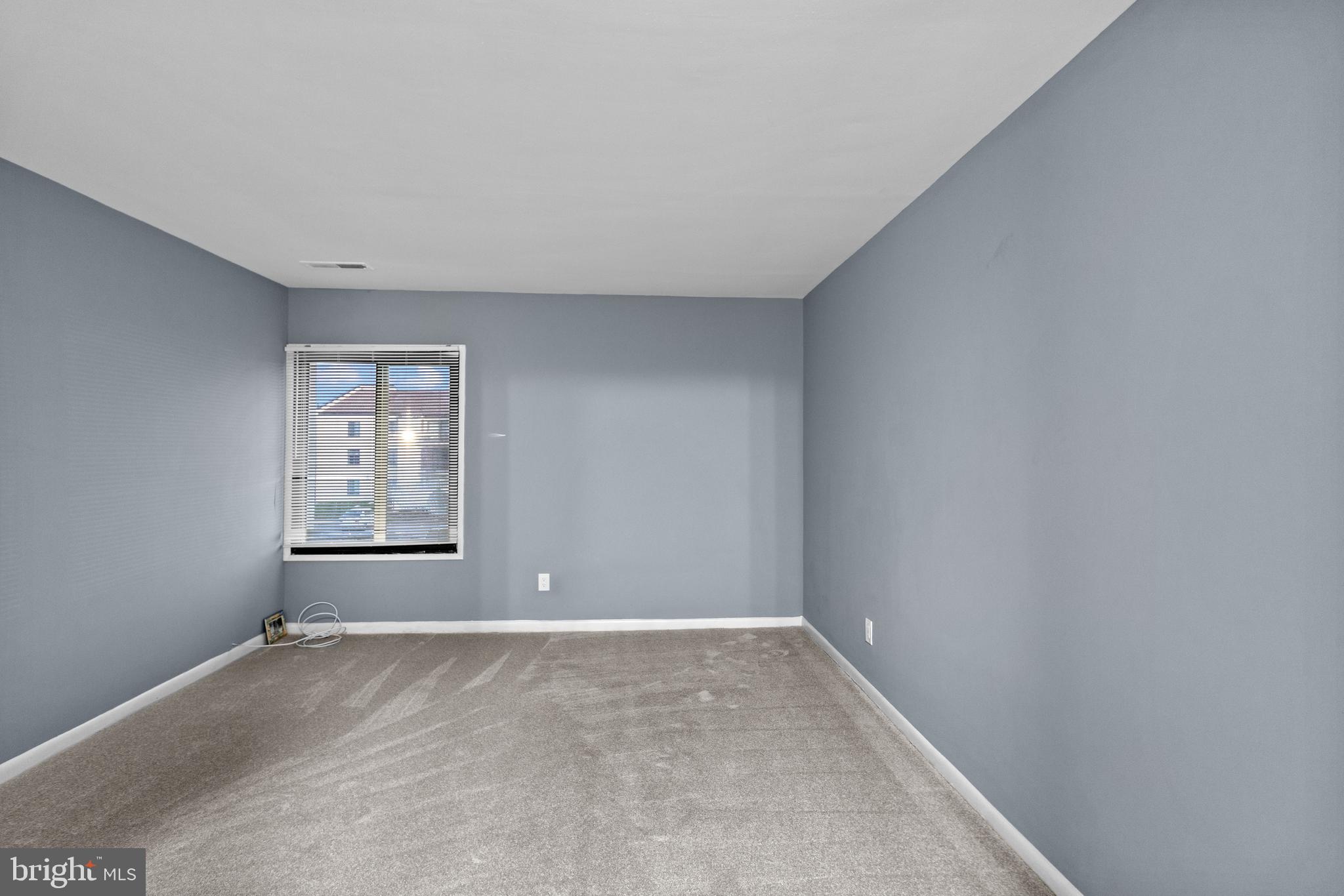 10121 Prince Place, Unit 30110B Upper Marlboro, MD 20774 - Photo 21 of 29 an empty room with windows
