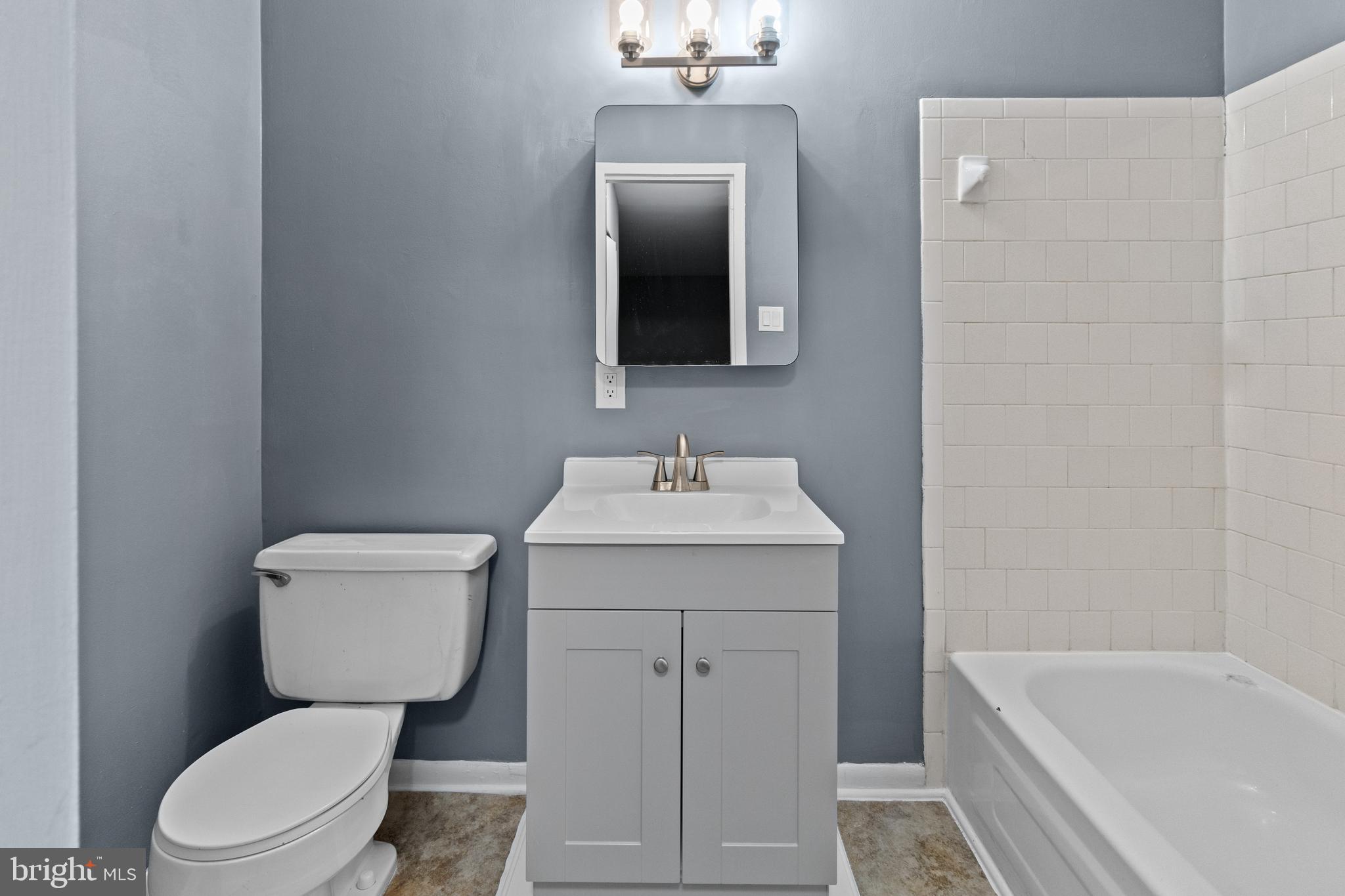 10121 Prince Place, Unit 30110B Upper Marlboro, MD 20774 - Photo 23 of 29 a bathroom with a toilet a sink and bathtub