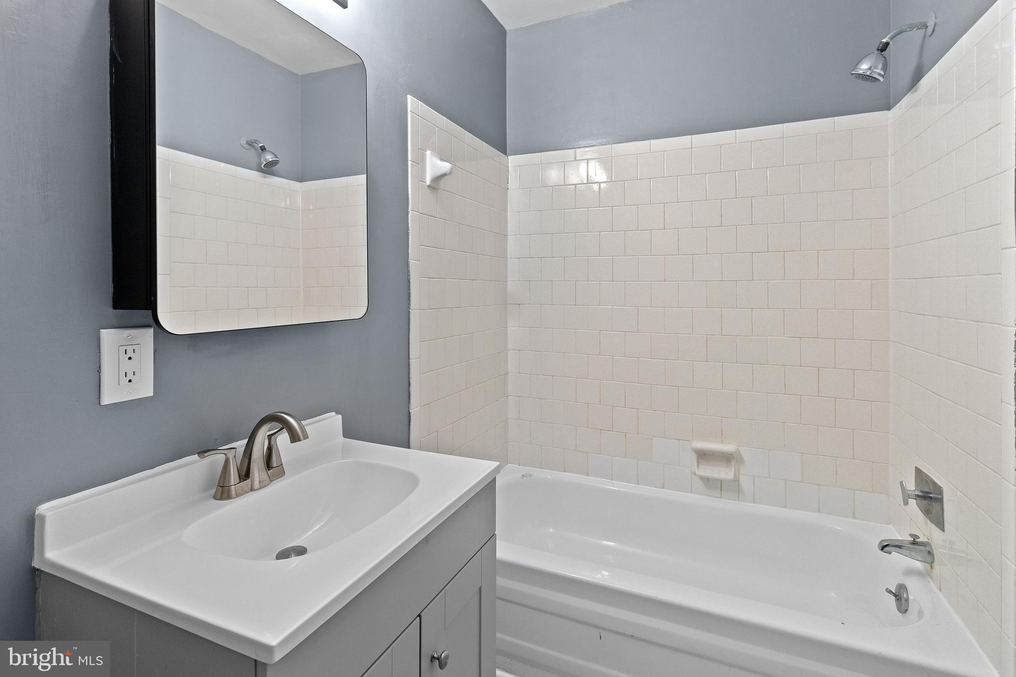 10121 Prince Place, Unit 30110B Upper Marlboro, MD 20774 - Photo 24 of 29 a bathroom with a sink and a bathtub