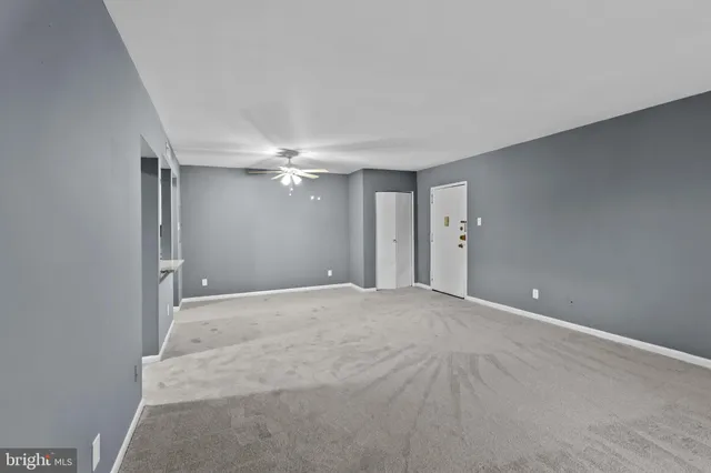 a view of an empty room with a ceiling fan