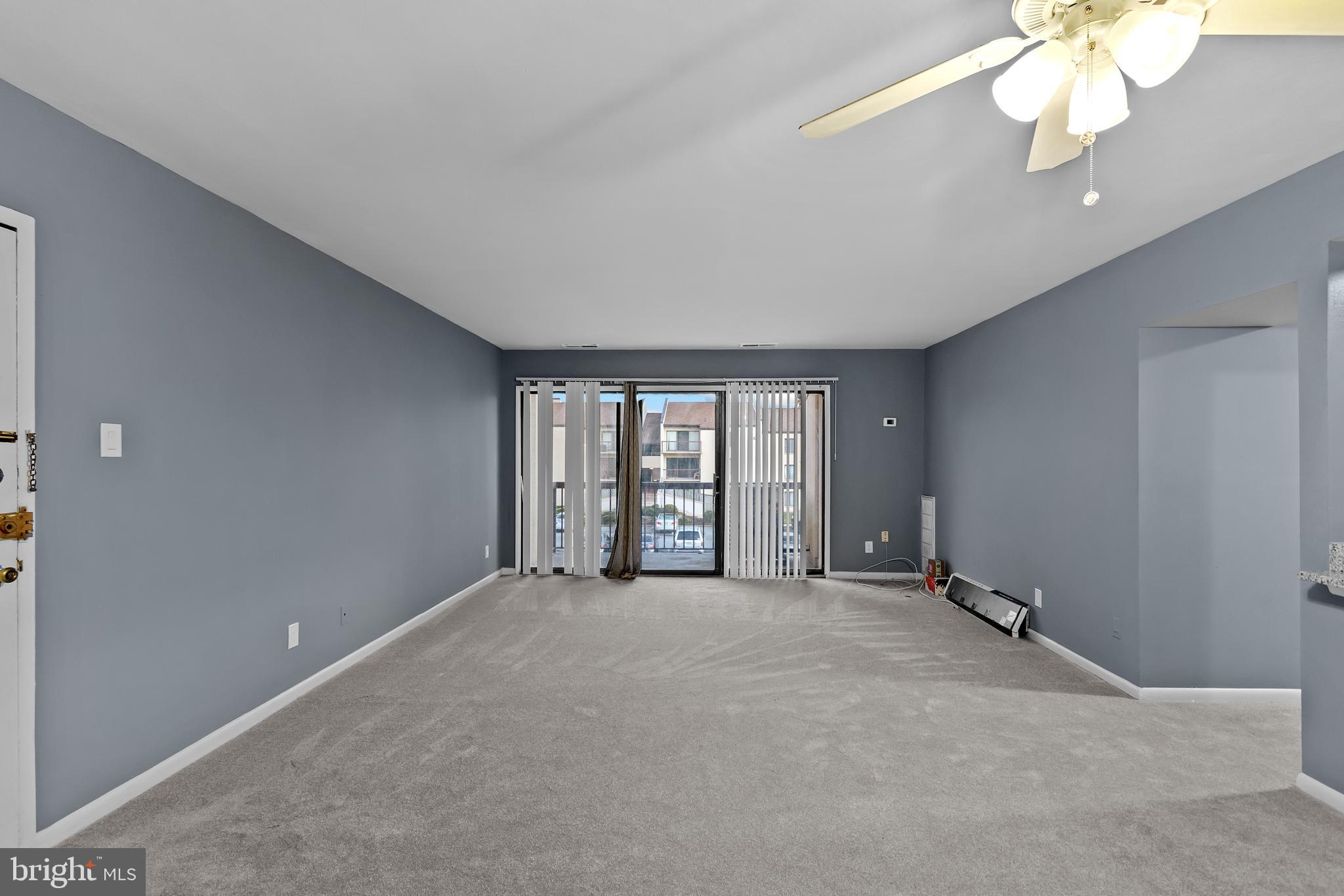 10121 Prince Place, Unit 30110B Upper Marlboro, MD 20774 - Photo 5 of 29 a view of an empty room with a window