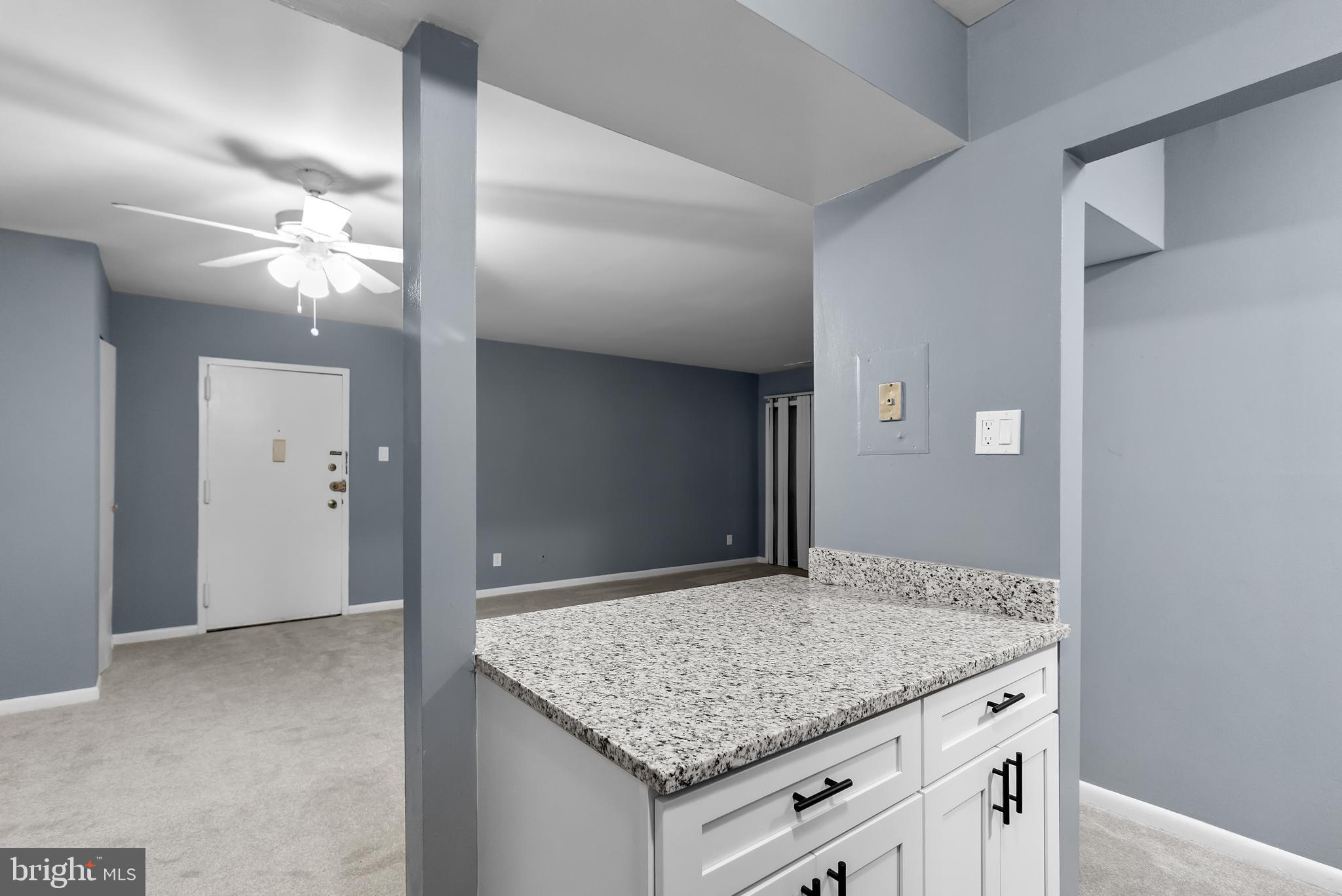 10121 Prince Place, Unit 30110B Upper Marlboro, MD 20774 - Photo 10 of 29 a bathroom with a granite countertop sink and a mirror