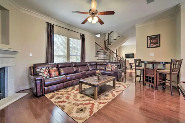 a living room with lots of furniture and a wooden floor