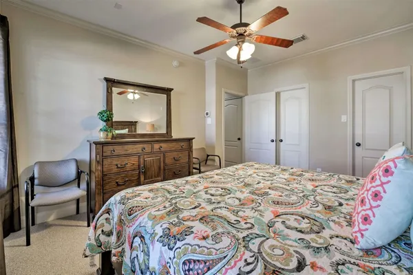a bedroom with a bed and a chair in it