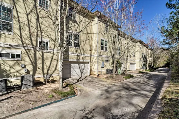 a backyard of a building with large trees