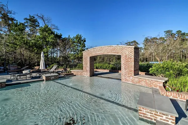 a view of a patio with a table and chairs under an umbrella