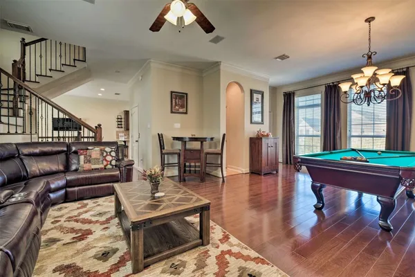 a living room with furniture a window and a chandelier