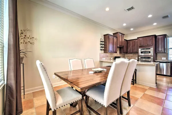 a dining room with furniture and a kitchen view