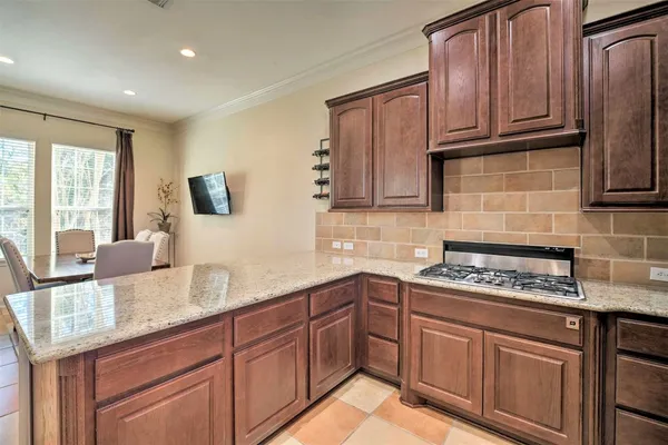 a kitchen with stainless steel appliances granite countertop a sink stove and cabinets