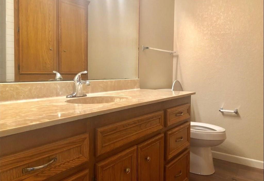 1317 Westheimer Road Abilene, TX 79601 - Photo 12 of 13 a bathroom with a sink a toilet and mirror