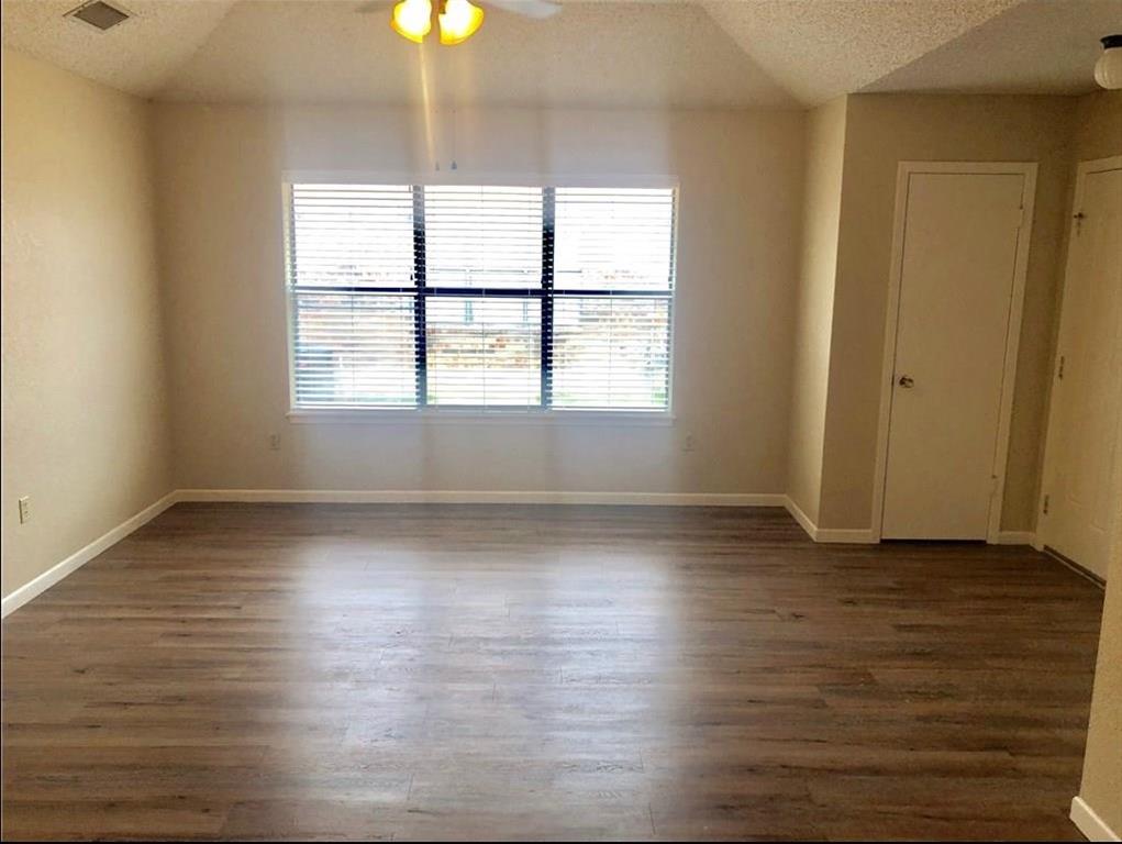 1317 Westheimer Road Abilene, TX 79601 - Photo 3 of 13 an empty room with wooden floor and windows