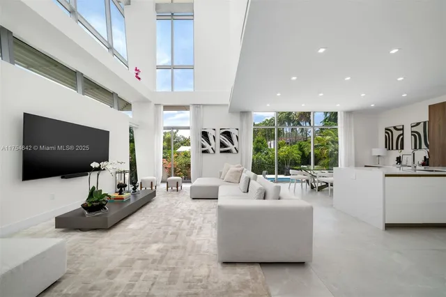 a living room with furniture and a entryway