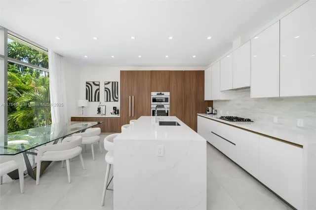 a bathroom with a double vanity sink bathtub and a window