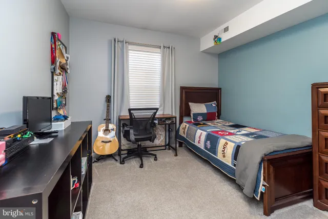 a bedroom with a bed and a desk