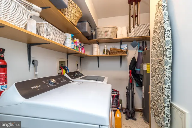 a living room with furniture a piano and a bookshelf