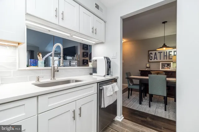 a kitchen with stainless steel appliances granite countertop a sink and cabinets