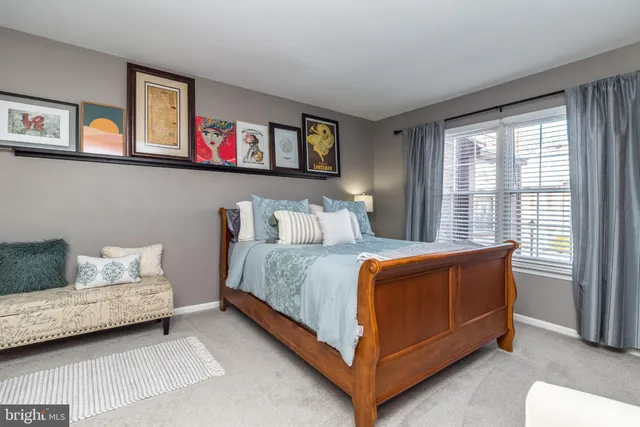 a bedroom with bed and painting on the wall