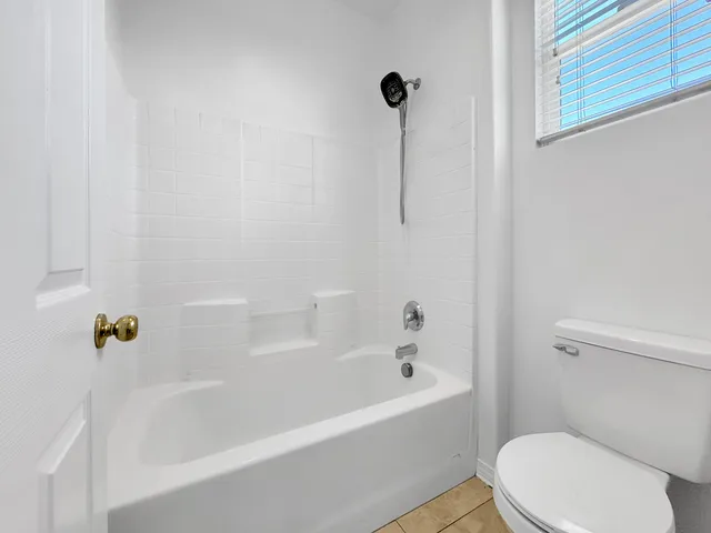 a white bath tub sitting next to a white toilet