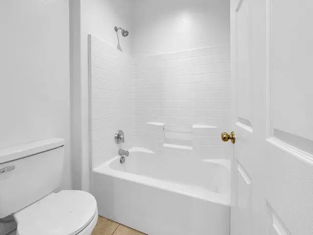 a white bath tub sitting next to a white toilet