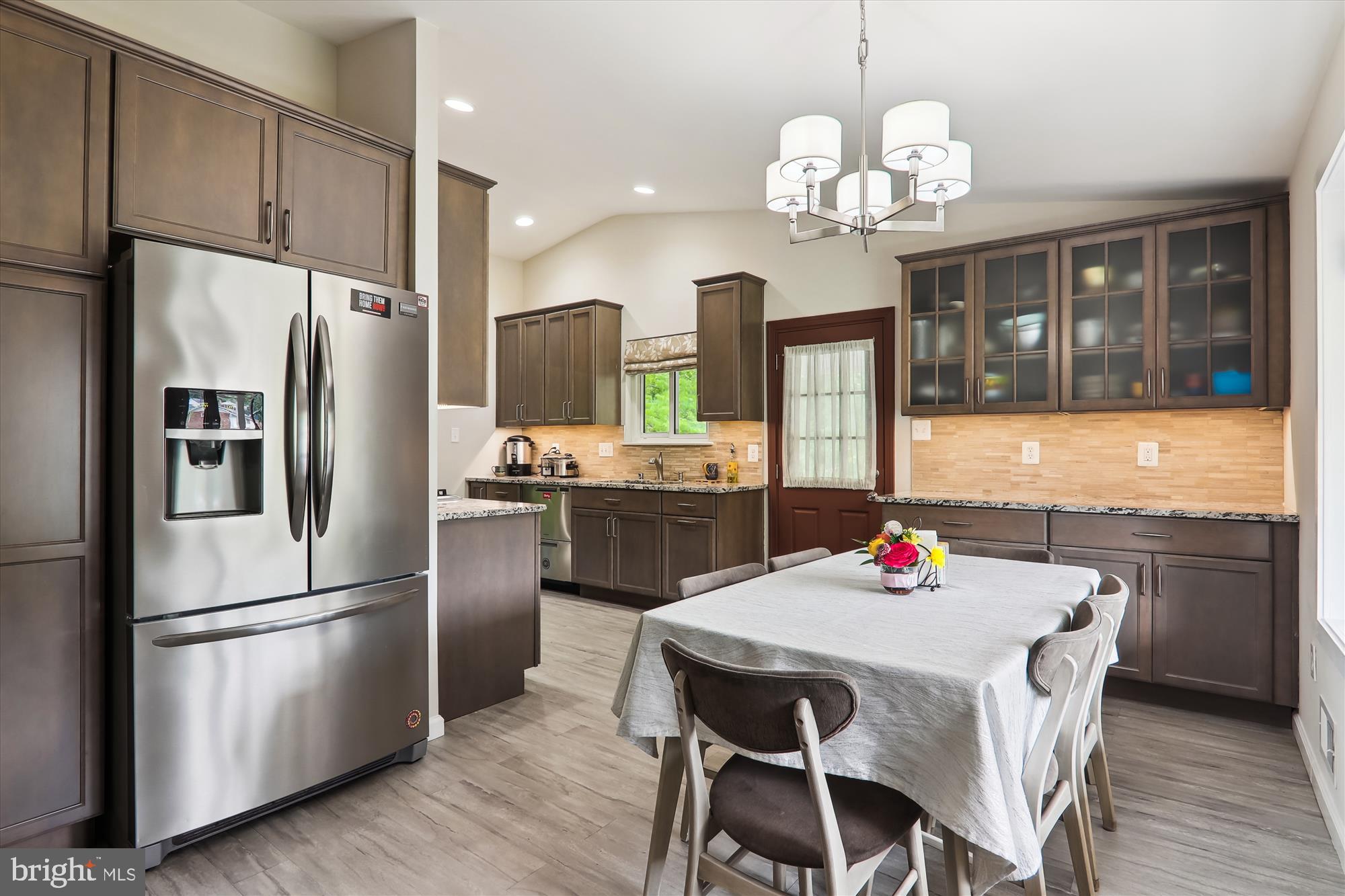 11804 Lovejoy Street Silver Spring, MD 20902 - Photo 17 of 45 a kitchen with refrigerator cabinets dining table and chairs